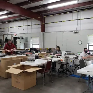 Workers carefully labeling products