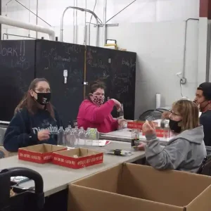 Staff applying product labels in a workshop environment